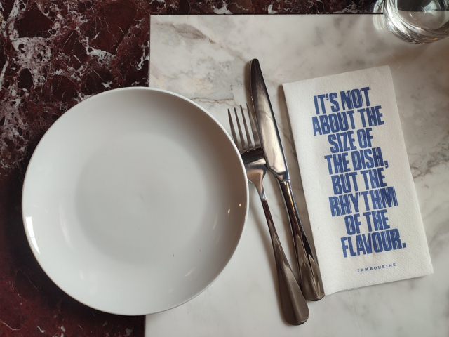 Small plates made for sharing on marble tables
