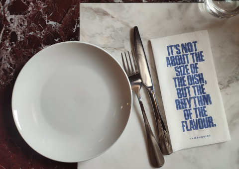Small plates made for sharing on marble tables
