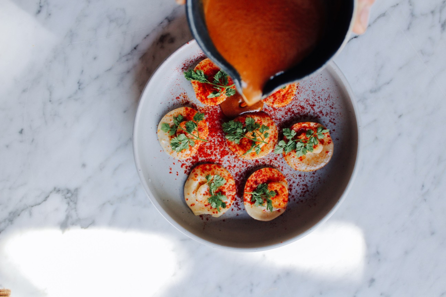 Bottoni pasta parcels filled with lemon and mascarpone, with charred octopus and seafood bisque
